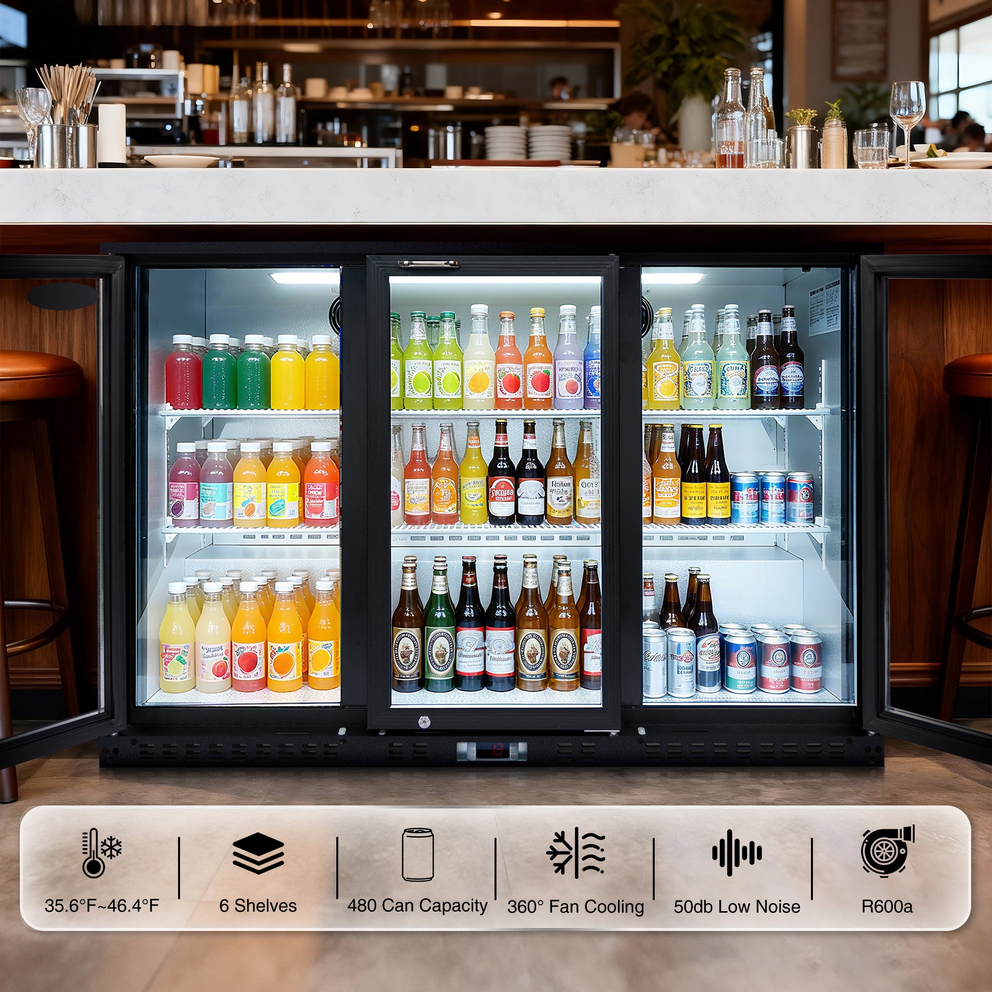 Under-counter three-door beverage cooler in a bar environment, displaying juices, sodas, and beer.